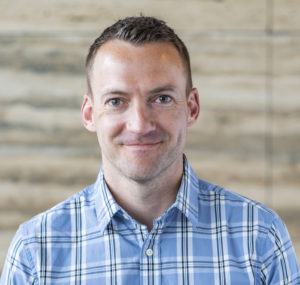 Ben Carlson posed in front of a neutral background