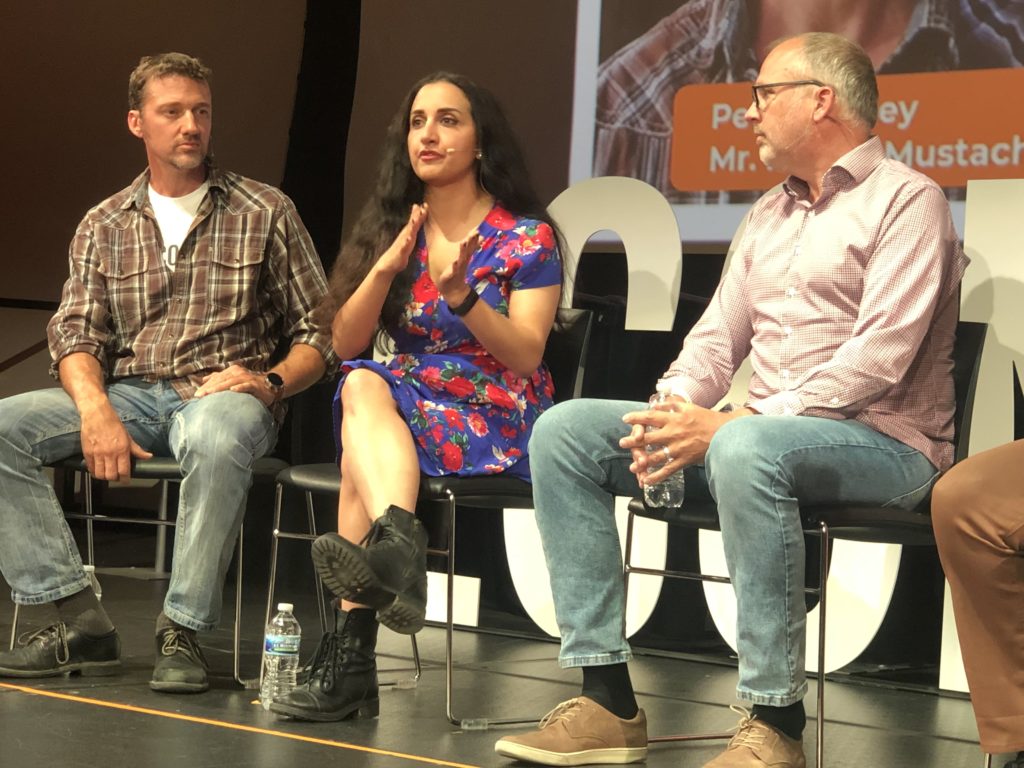 mr. money mustache and paula pant on stage at EconoMe, a conference about financial independence